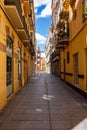 Vertical shot of a lonely and empty street with residential buildings in Malaga, Spain
