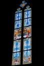 Vertical shot of a long window with stained glass designs in a building