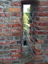 Vertical shot of a loophole in a brick wall of the Brederode castle in the Netherlands Royalty Free Stock Photo