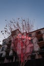 Vertical shot of a love neon sign on a tree near a Christmas castle in Qinhuangdao, China