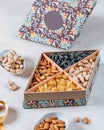 Vertical shot of luxurious gift box with a variety of nuts and dried fruits