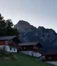 Vertical shot of luxury country houses on a hill with a background of rough mountains Royalty Free Stock Photo