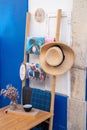 Vertical shot of magazines on a wooden stand with a straw hat in a cafe shop