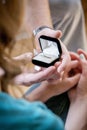 Vertical shot of a male giving a promise ring to his girlfriend