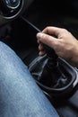 Vertical shot of male hand on handle of six-speed manual gearbox Royalty Free Stock Photo