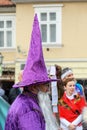 Vertical shot of a male wearing purple wizard costume at carnival