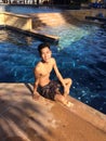 Vertical shot of a male wearing swimsuit at a pool Royalty Free Stock Photo