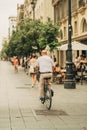 Vertical shot of a man biking in the street in Sevilla, Spain