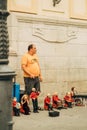 Vertical shot of a man selling musicians' statues in a street in Sevilla, Spain