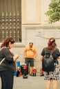 Vertical shot of a man selling musicians' statues in a street in Sevilla, Spain