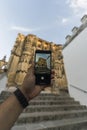 Vertical shot of a man taking a photo of St. Mary Parish Church in Arcos de la Frontera