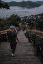 Vertical shot of a man walking down the stairs of Mount Tapyas in Coron Island, Palawan, Philippines