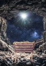 Vertical shot of a manger in a cave under a bright starry sky during the birth of Jesus Christ Royalty Free Stock Photo