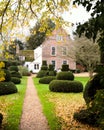 Vertical shot of the Manor with boxwoods in the yard in Hemingford Grey, Cambridgeshire, England Royalty Free Stock Photo