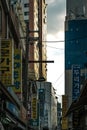 Vertical shot of a market, trading street in Seoul, South Korea, with lots of banners and ad signs