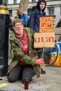 Vertical shot of a mature male Extinction Rebellion Protester holding home made signs at a protest march Royalty Free Stock Photo