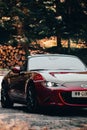 Vertical shot of a Mazda MX5 red car in nature Royalty Free Stock Photo