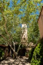 Vertical shot of a Mediterranean-style courtyard with lots of trees.