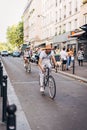 Vertical shot of men biking in the street in Sevilla, Spain