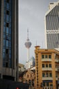 Vertical shot of Menara tower between skyscrapers from Chinatown, KL
