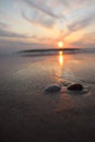 Vertical shot of a mesmerizing calm sunset over the sea shore Royalty Free Stock Photo