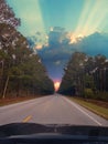 Vertical shot of a mesmerizing sunset over the highway road from the car Royalty Free Stock Photo