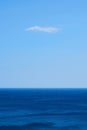 Vertical shot of a mesmerizing tranquil ocean under the blue sky