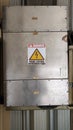 A vertical shot metal container Electrical panel high voltages with symbol danger. Sign Indonesia language. Royalty Free Stock Photo