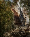 Vertical shot of a metal stair in the hiking area Sentier Blanc-Martel with trees