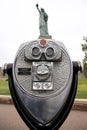 Vertical shot of a metal tower viewer with an amazing view of the Statue of Liberty