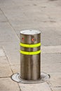 Vertical shot of a metallic bollard with red illuminated lights Royalty Free Stock Photo