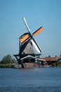 Vertical shot of a mill called Het Jonge Schaap near the sea, with sky background, Zaandam