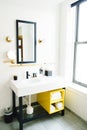 Vertical shot of a minimal modern bathroom with a bold design and yellow accents