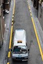 Vertical shot of a minivan Piaggio Porter utility on the street