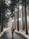 Vertical shot of a model walking in a park during winter