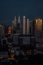 Vertical shot of the modern cityscape of Kuala Lumpur In the evening with sunlight reflecting