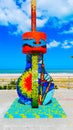 Vertical shot of the modern mosaic art sculpture near a shore