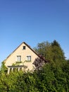 Vertical shot of a modern rural house surrounded by green summer foliage in the countryside Royalty Free Stock Photo