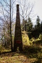 Vertical shot of a monument with red writings in a forest in Gucevo, Serbia, on a sunny day