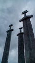 Vertical shot of a monument ''Swords in rock'' under the gloomy sky in Stavanger, Norway