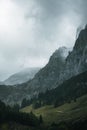 Vertical shot of moody mountains and dramatic clouds in Berchtesgaden, Germany.