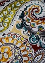 Vertical shot of a multi-colored wavy paisley design pattern on soft fabric