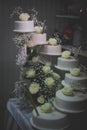 Vertical shot of a multi-tier white cake with flower decorations