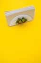 Vertical shot of a napkin holder with strawberry detail on yellow background - copy space