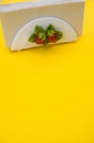 Vertical shot of a napkin holder with strawberry detail on yellow background - copy space