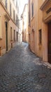 Vertical shot of a narrow alley in San Gimignano, Italy Royalty Free Stock Photo
