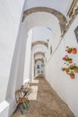 Vertical shot of narrow arcaded street in Vejer de la Frontera o