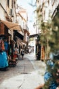 Vertical shot of a narrow shopping street in Calvi city