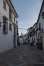 Vertical shot of narrow street with buildings with windows in Cordoba city, Andalusia, Spain