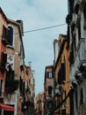 Vertical shot of a narrow street with colorful buildings with windows